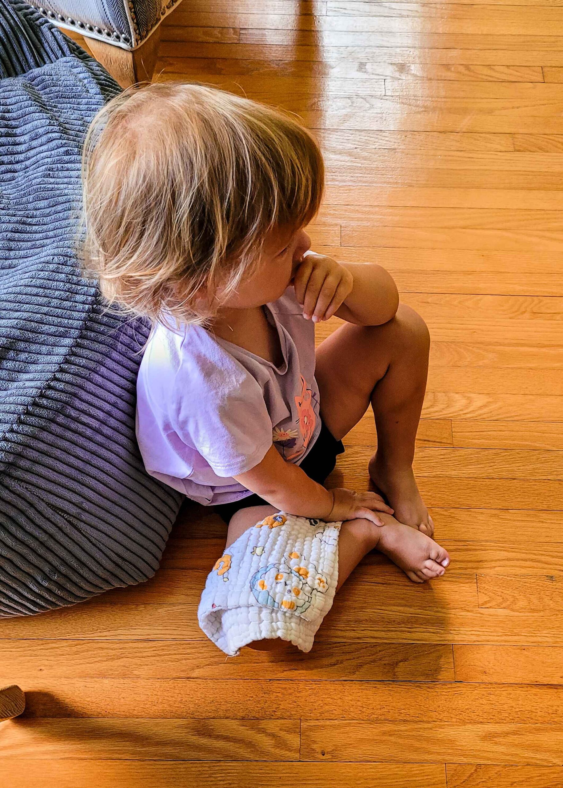 Daughter sitting on the floor with a lilac top