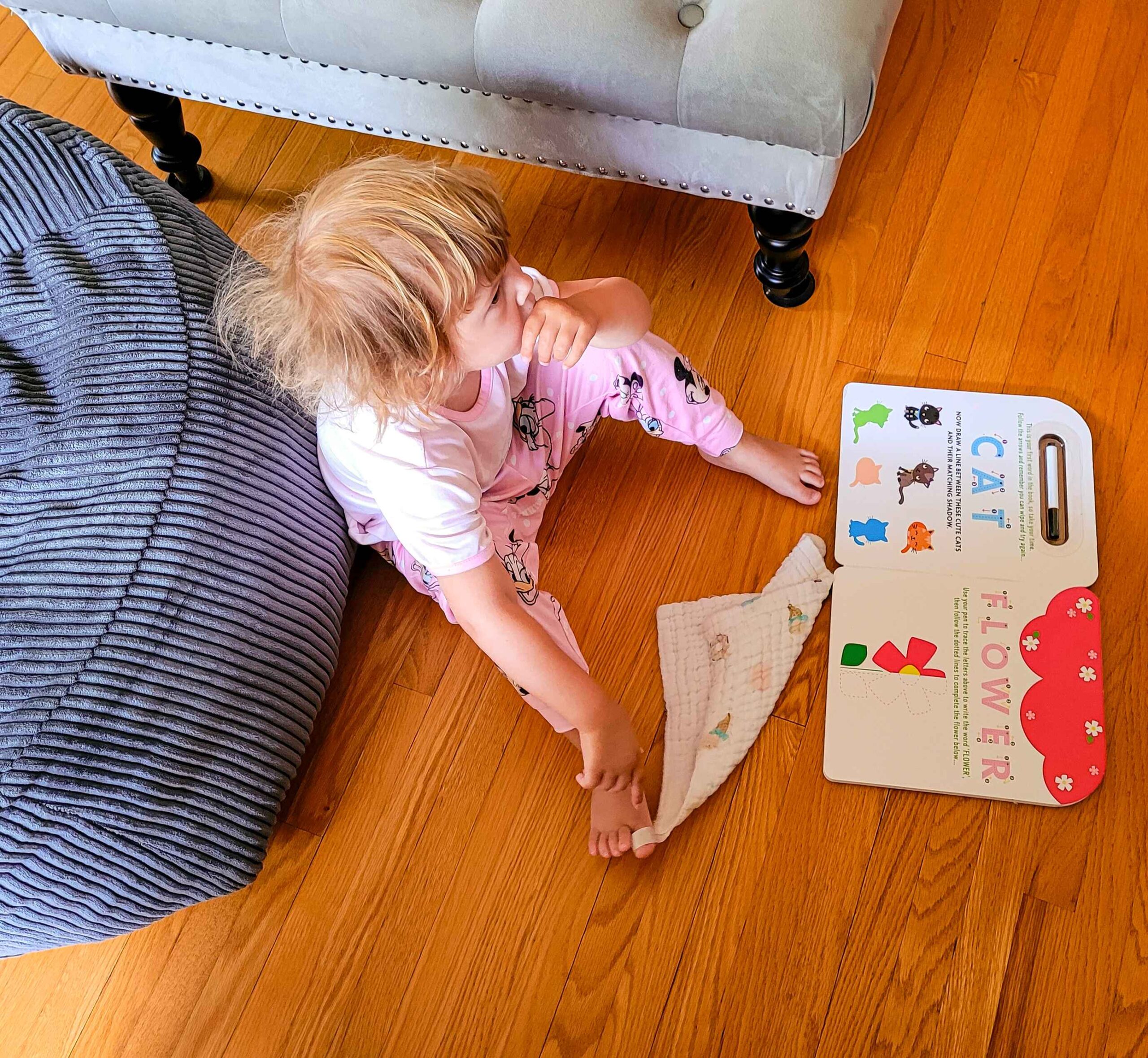 a little girl looking with book infront