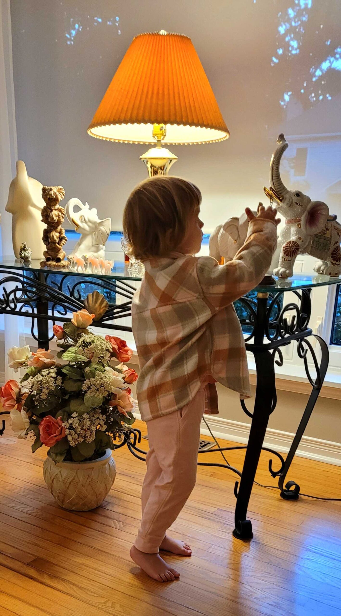 My daughter reaching for elephant wearing fall outfit